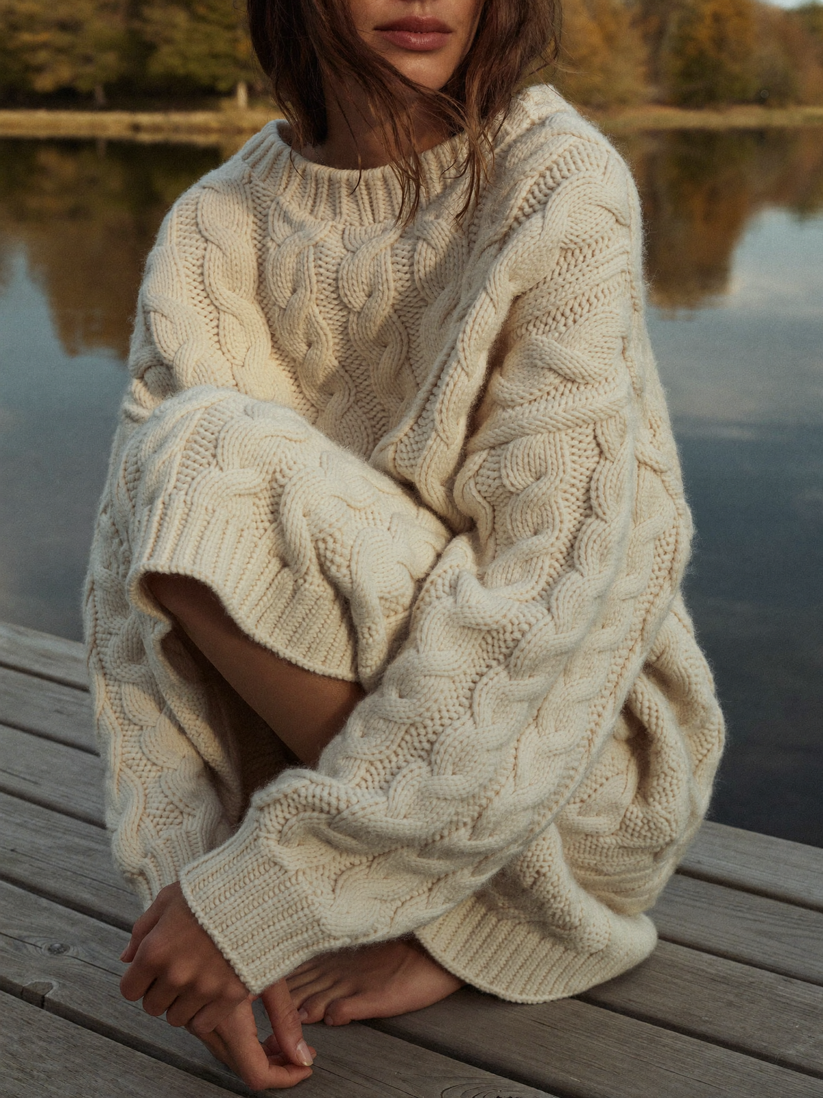 Cable-knit sweater by the lake