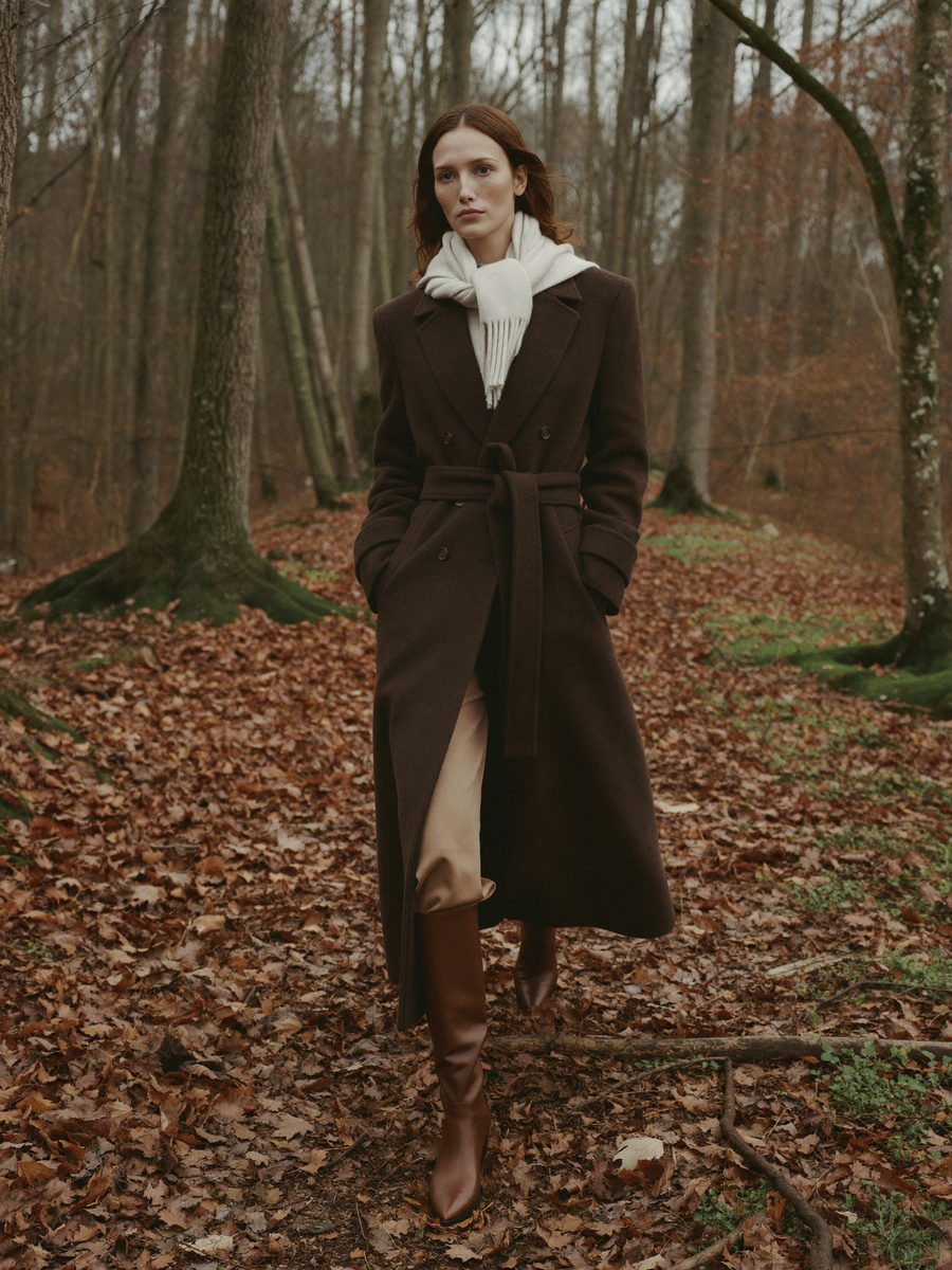 Chocolate wool coat on a forest trail