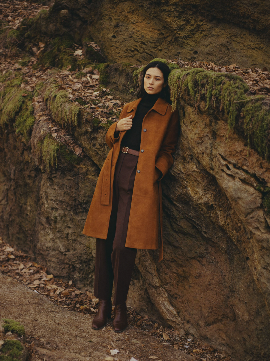 Cognac suede trench by a sandstone wall
